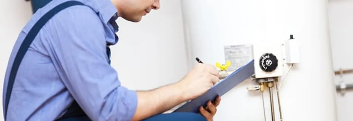 Water heater repair technician inspecting the unit and recording service notes in Stockton, CA